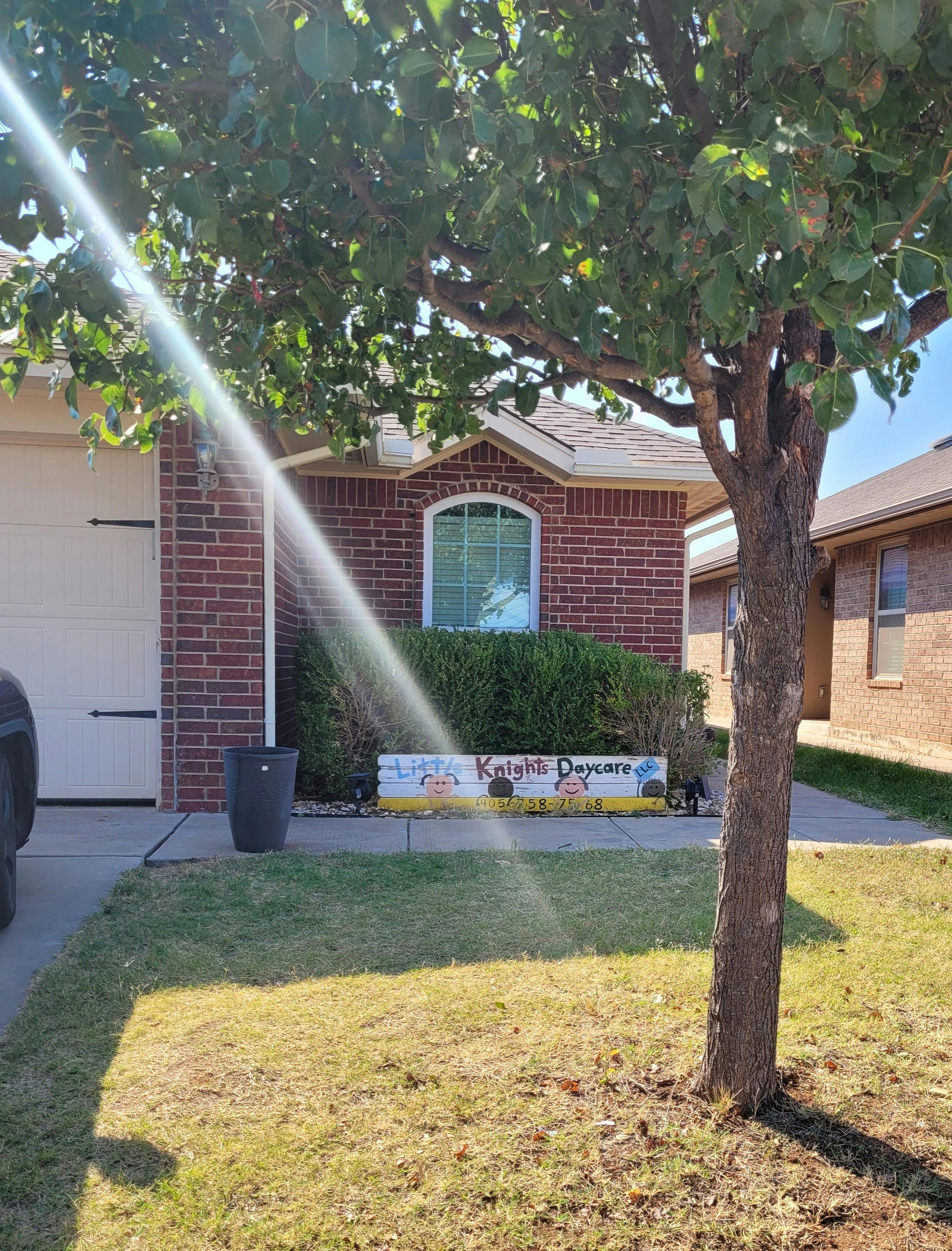 House with a "Knights Daycare" sign in front