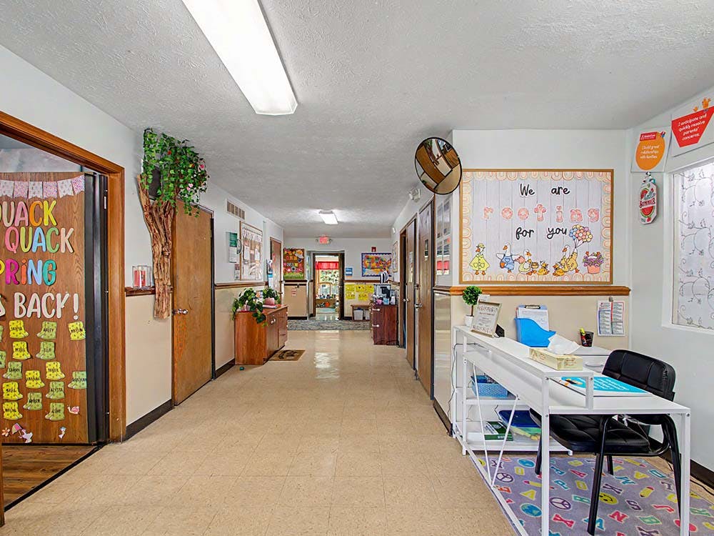 Hallway with decorated doors and a bulletin board saying "We are rooting for you"