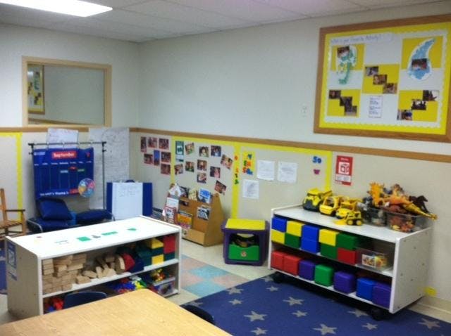 Classroom with toy shelves, calendar, and bulletin boards