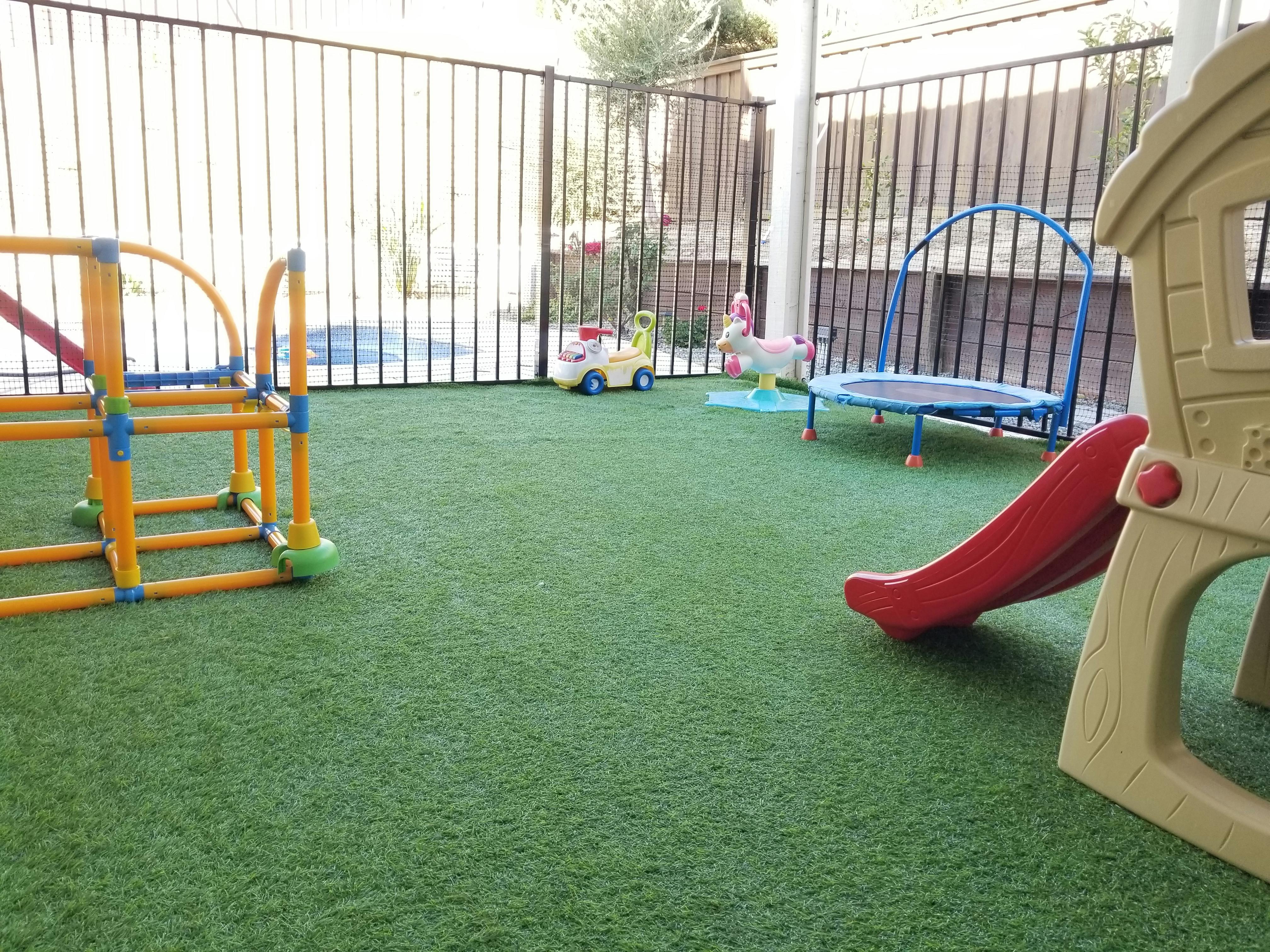 Playground with artificial turf, slide, and climbing structure