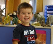 Child smiling in a classroom