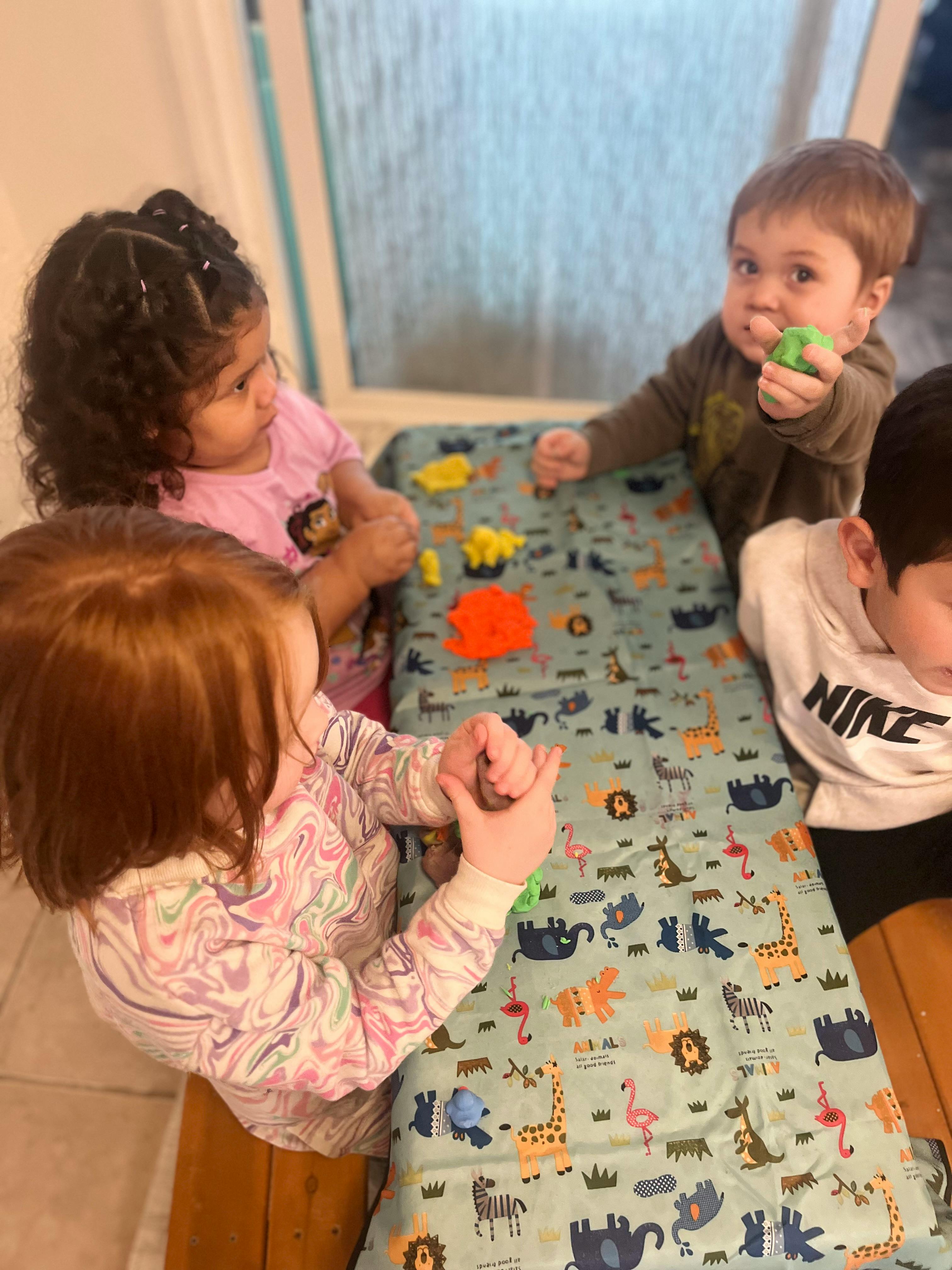 Children playing with toys on a patterned mat