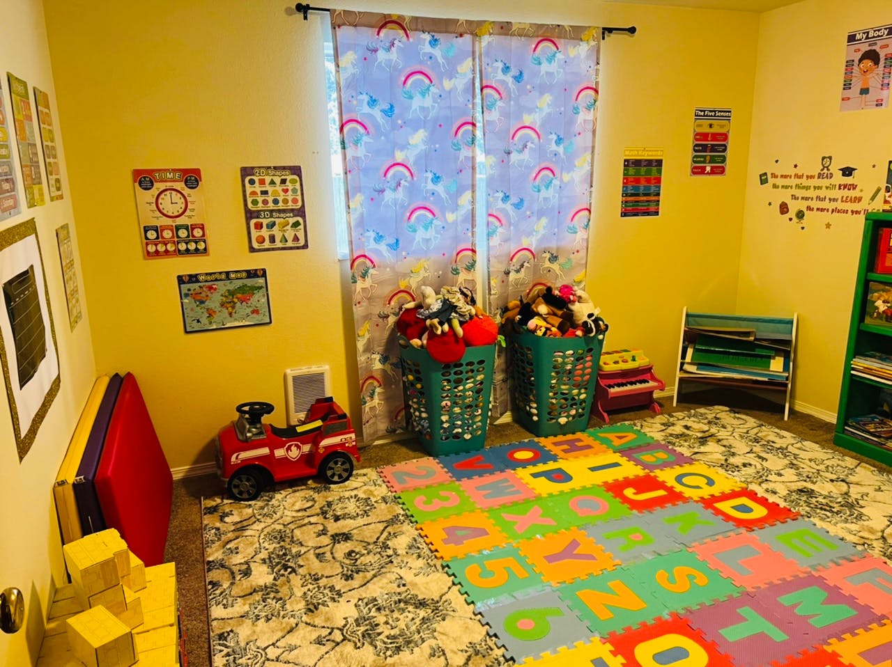 Playroom with alphabet mat, toy car, and two laundry baskets filled with toys