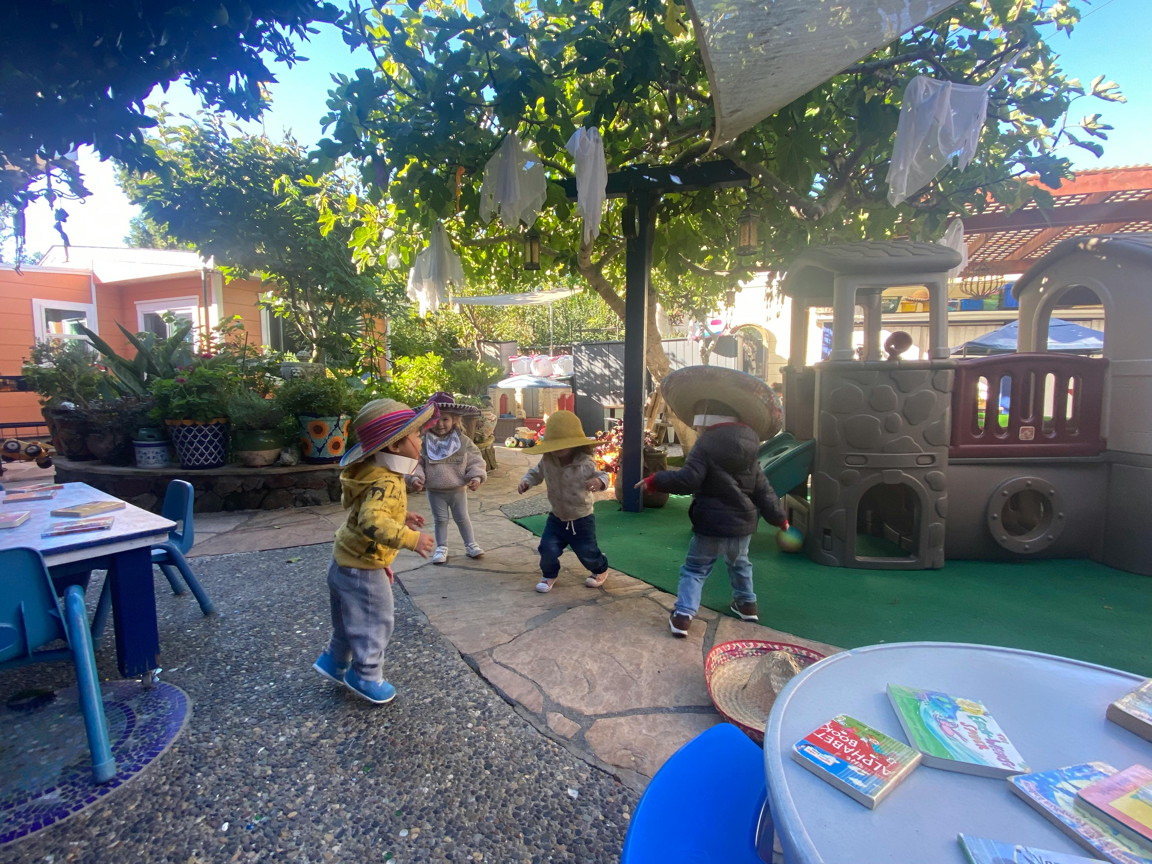 Children playing outdoors near a play structure