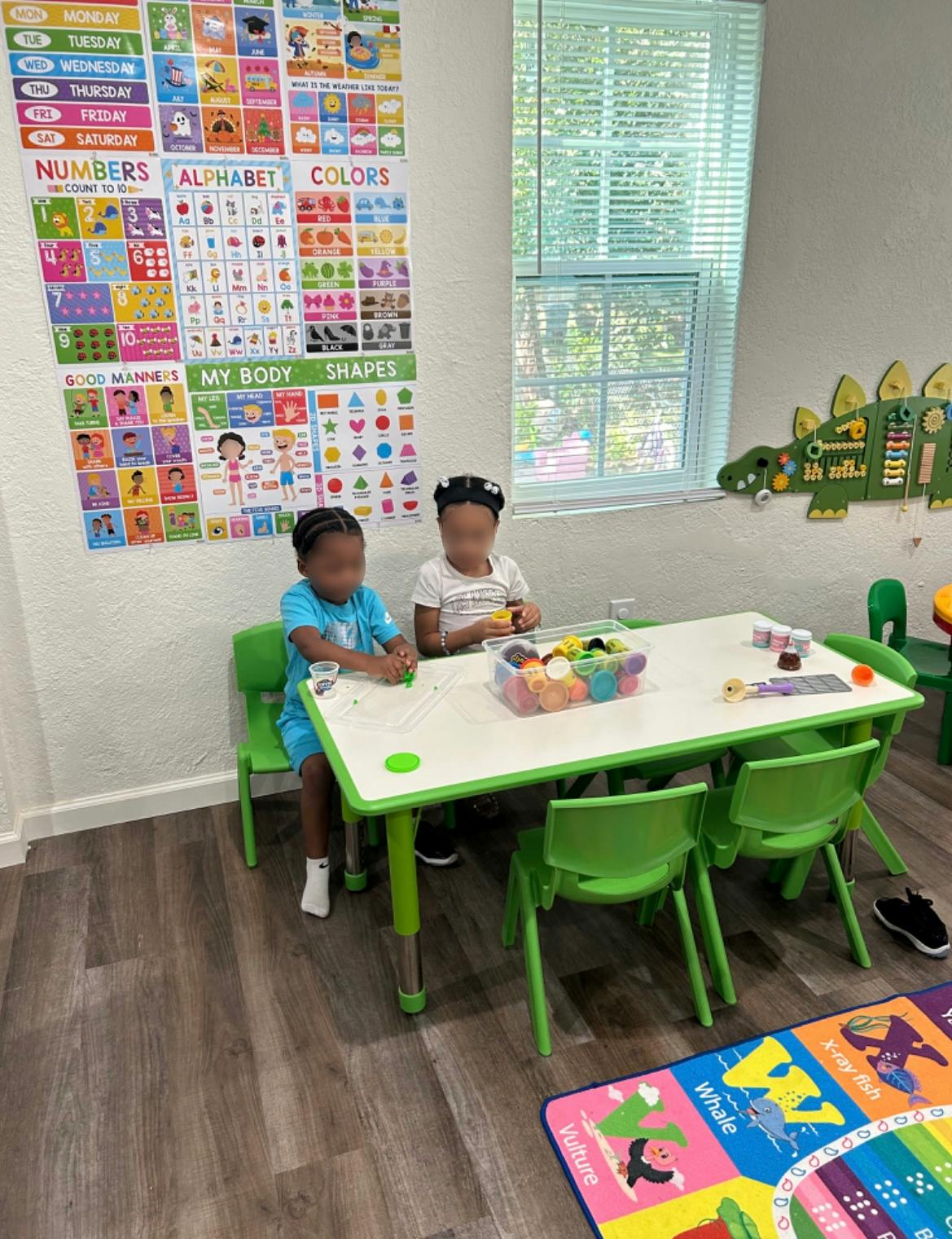 Two children sitting at a table in a classroom