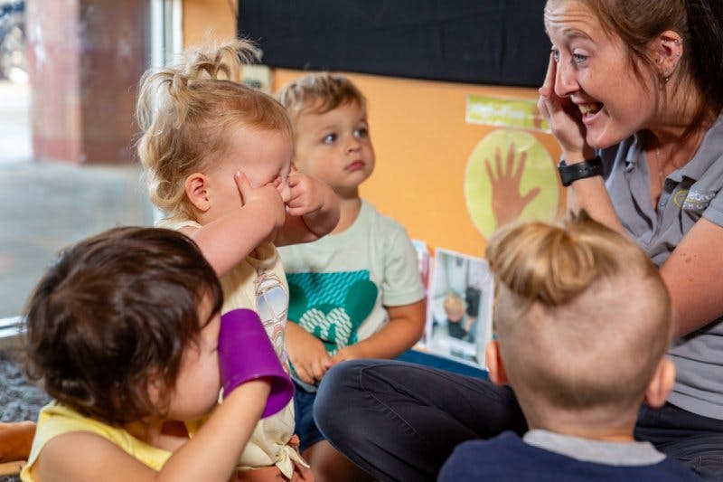 Adult person interacting with three children
