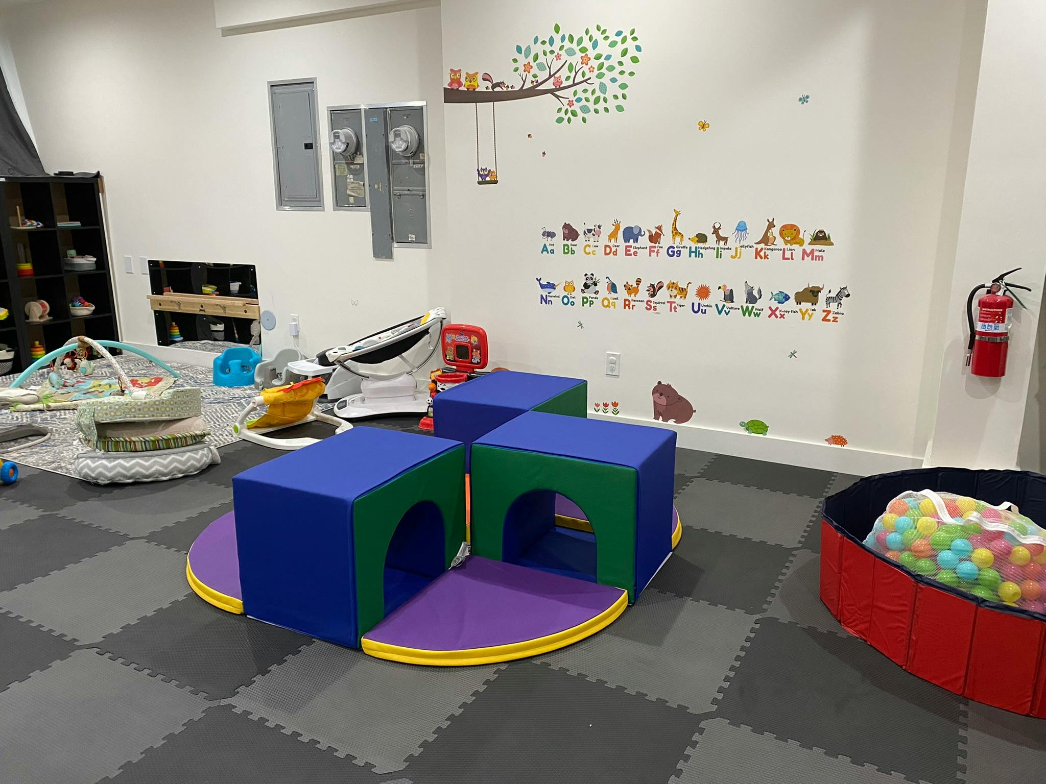 Indoor play area with soft play structures and a ball pit