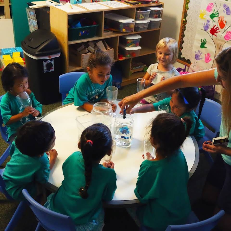 Children gathered around a table for an activity