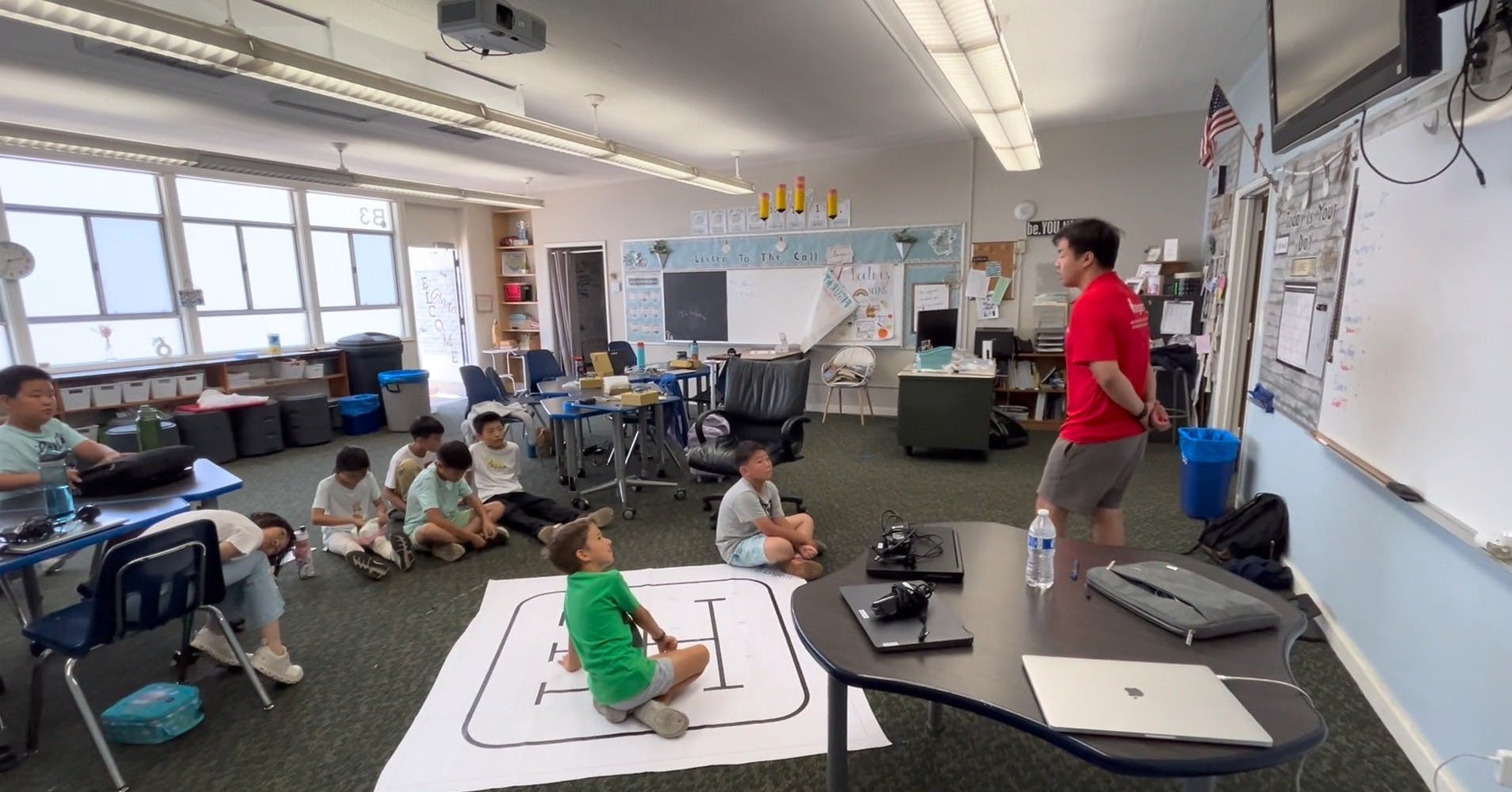 Person teaching children in a classroom setting