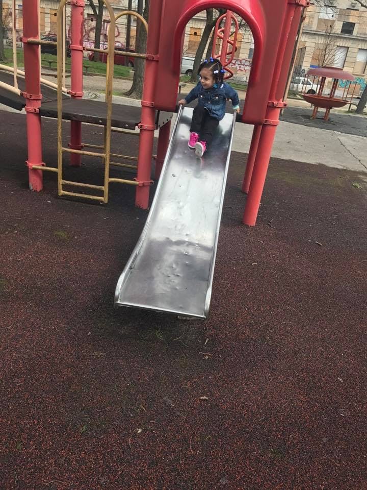 Child going down a slide on a playground