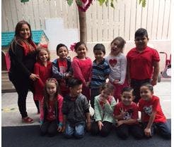 Adult and group of children posing for a photo