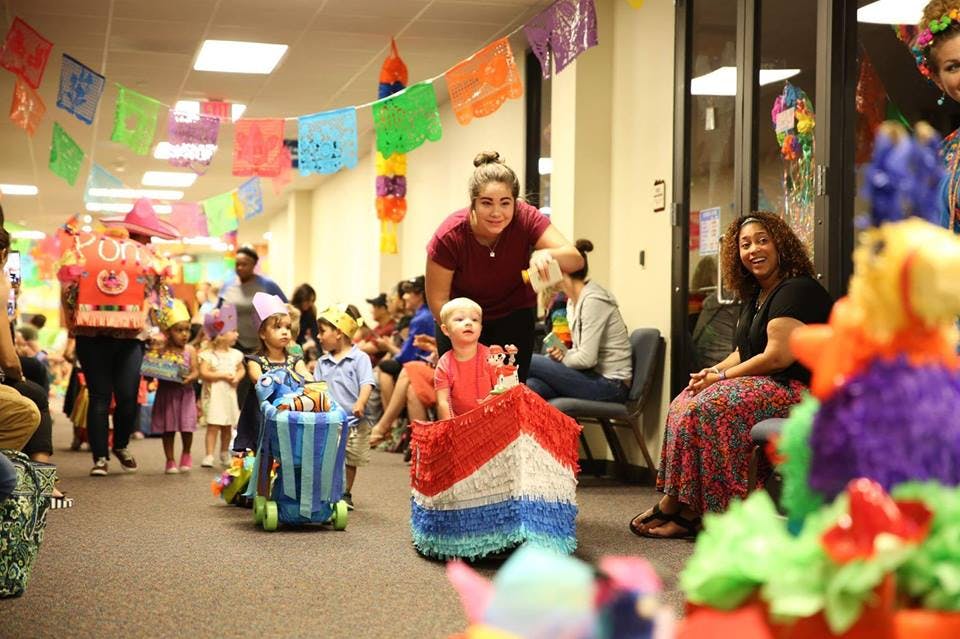 People and children in a decorated room