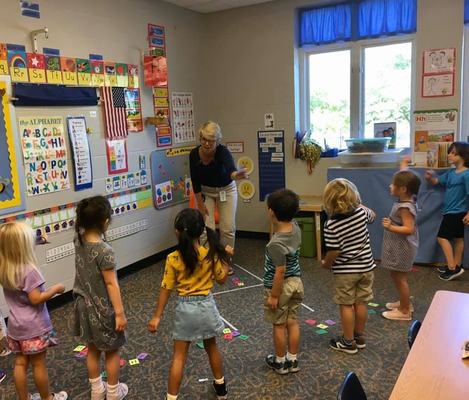 Adult and children in a classroom