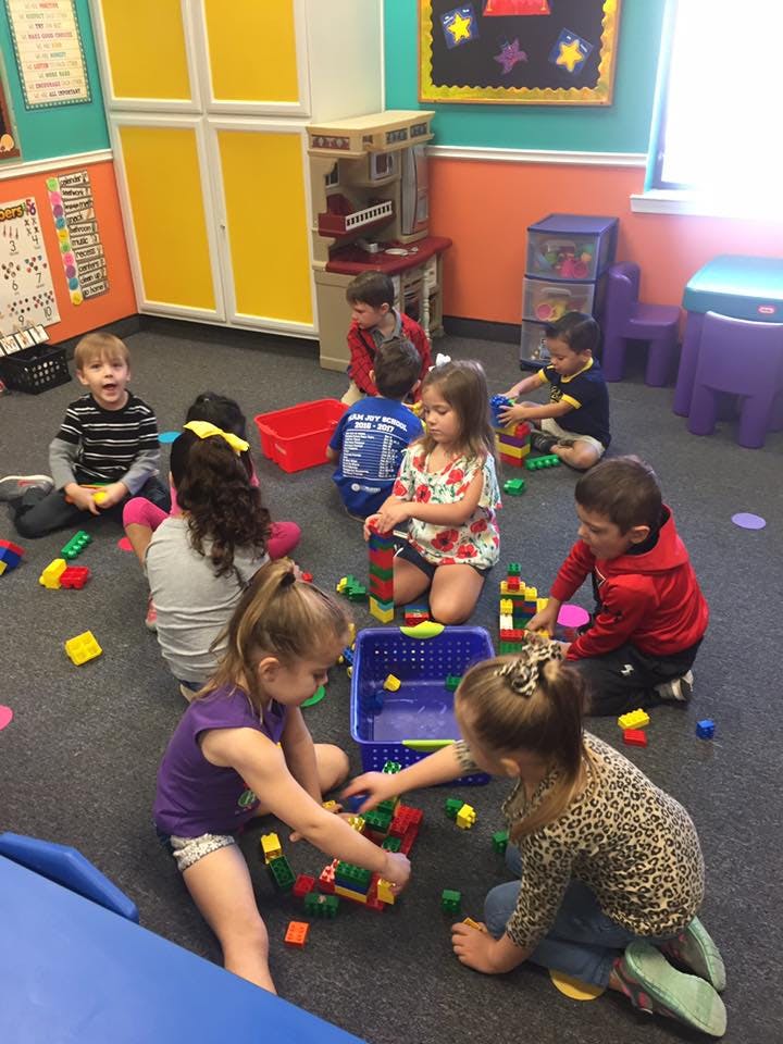 Children playing with building blocks on the floor