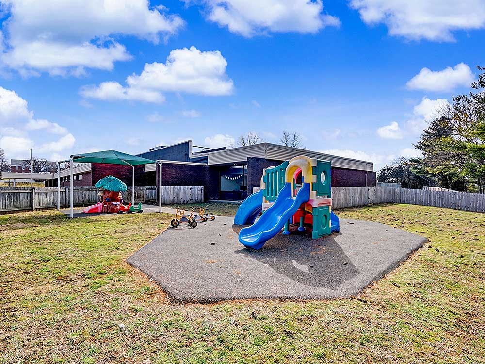 Playground with colorful slides and a mushroom-shaped play structure