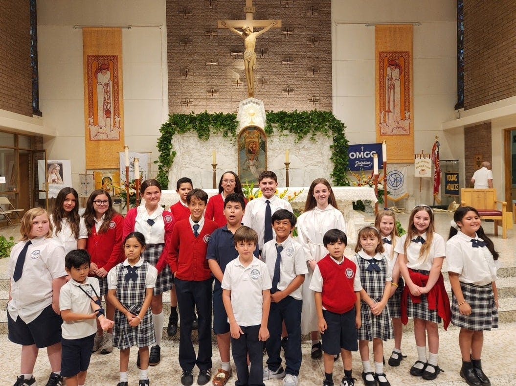 Group of children and teens in school uniforms standing in a church