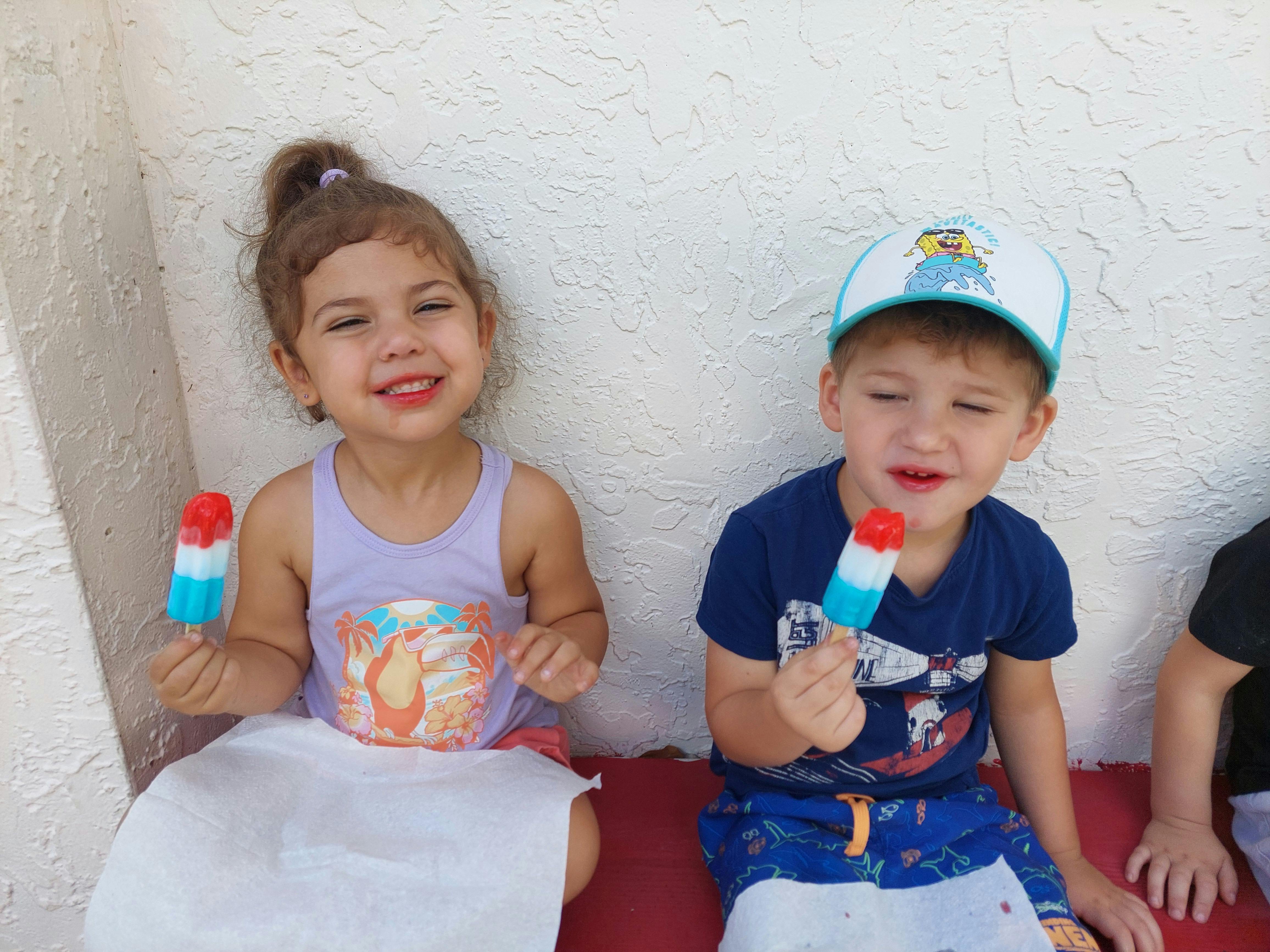 Two children holding popsicles