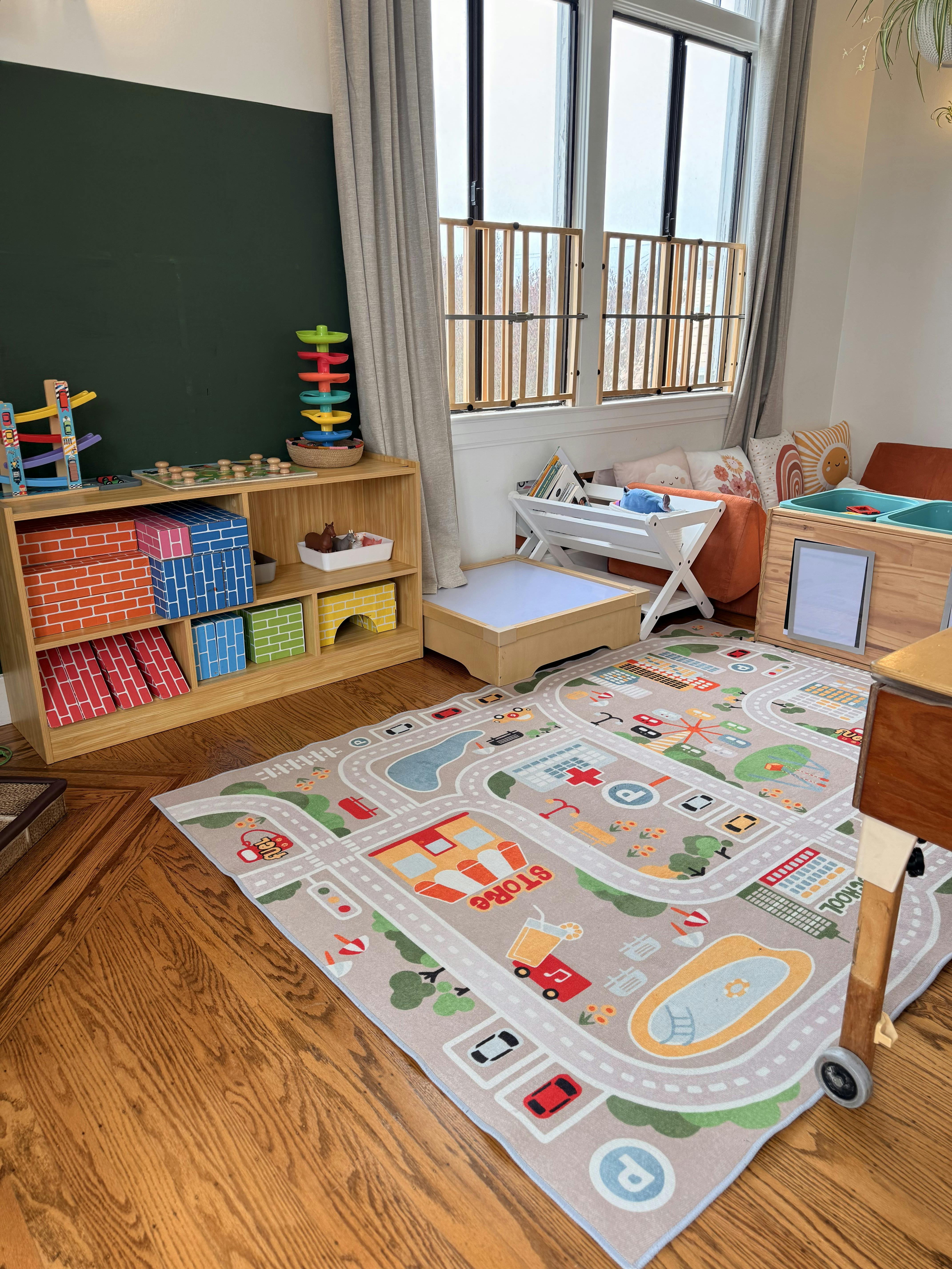 Playroom with a road map rug, toy storage shelves, and child furniture