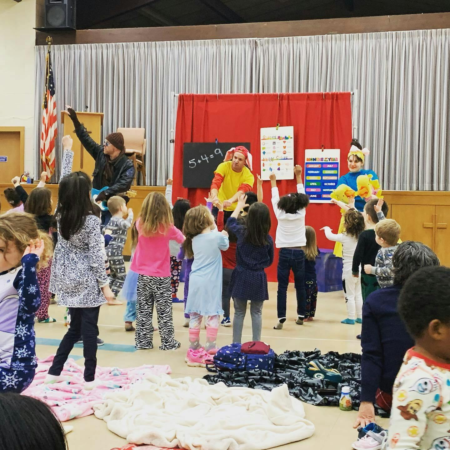 Children watching and interacting with performers on a stage