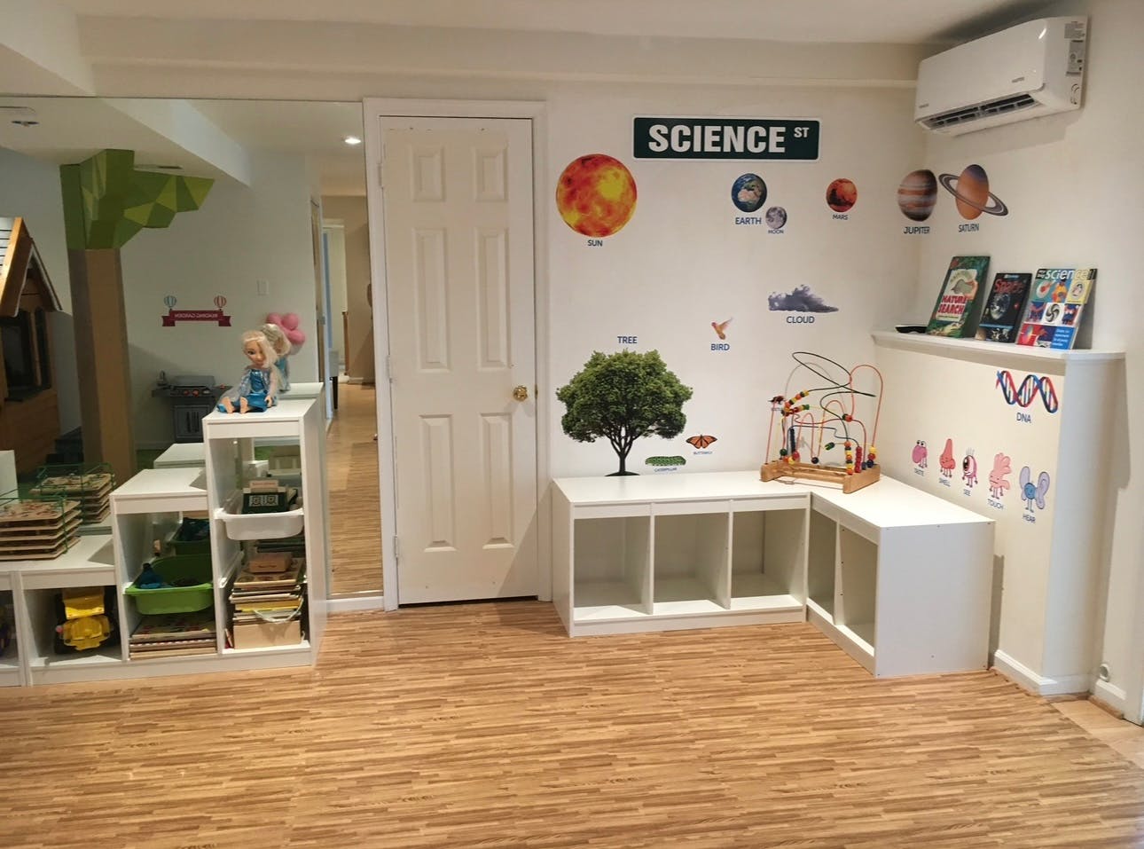 Classroom with science-themed wall decorations and storage shelves