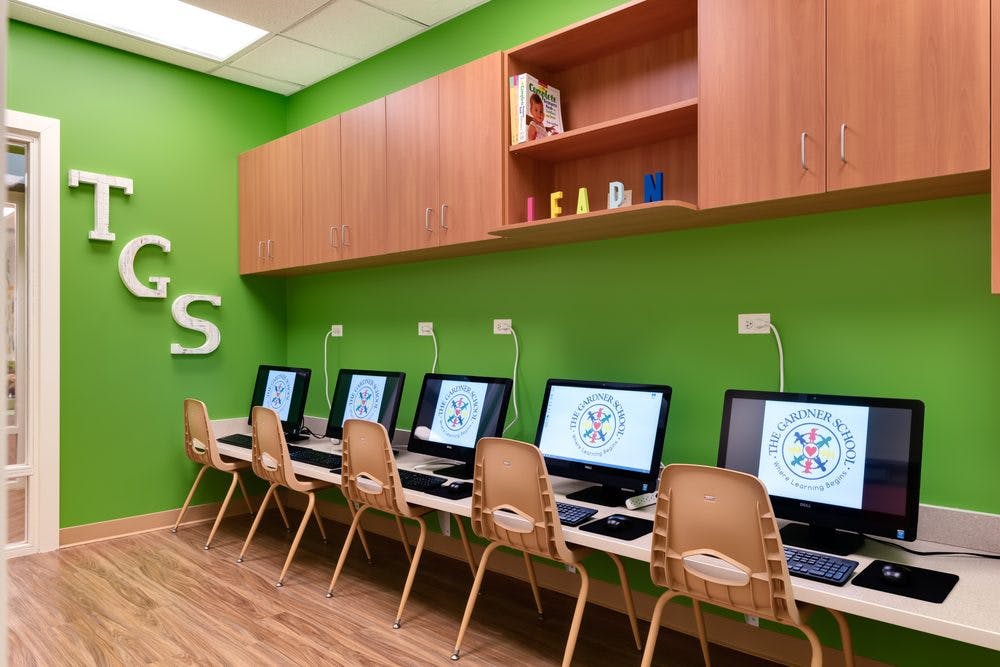 Row of computers with chairs in a classroom