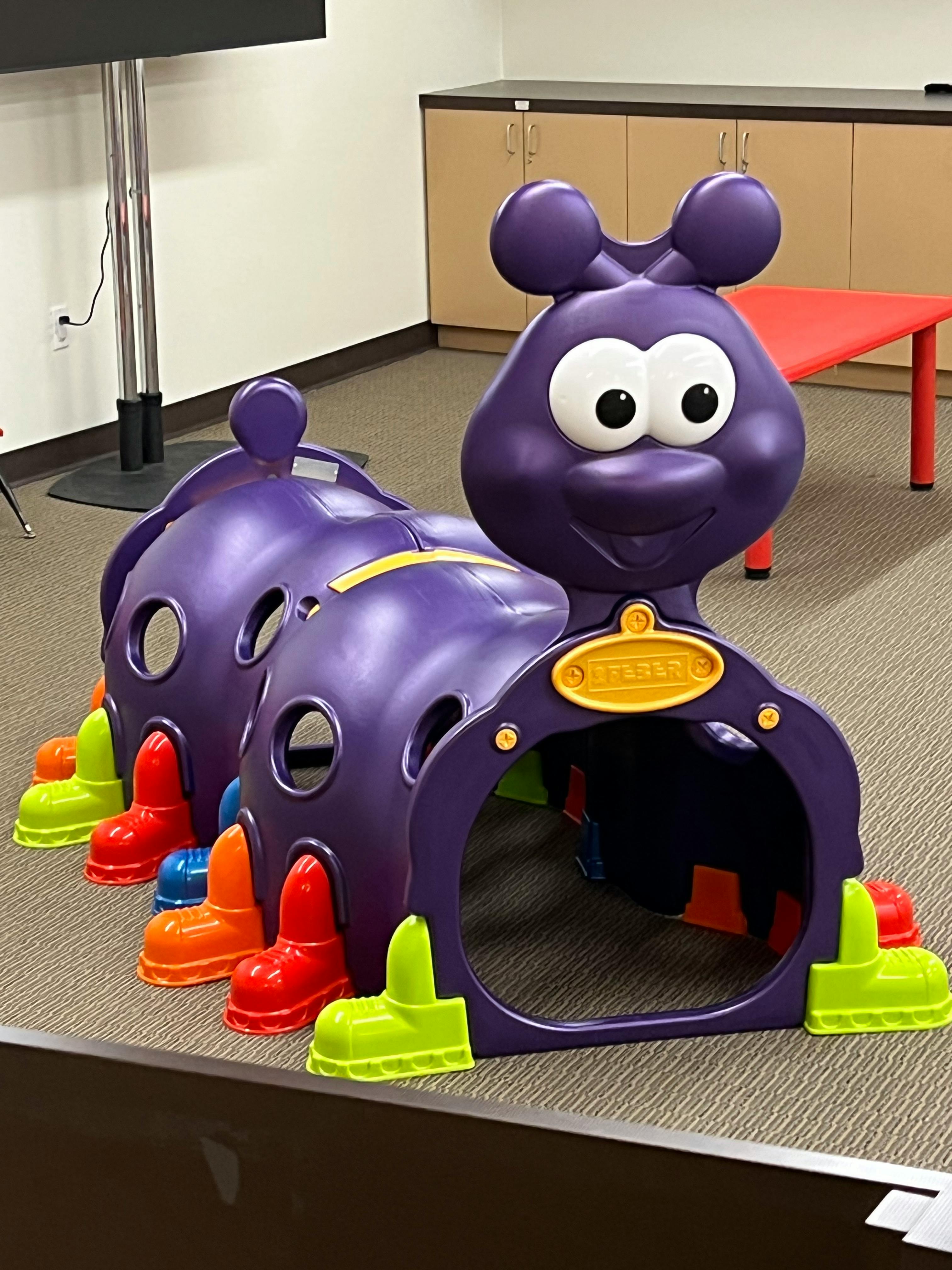 Purple caterpillar play tunnel with colorful feet