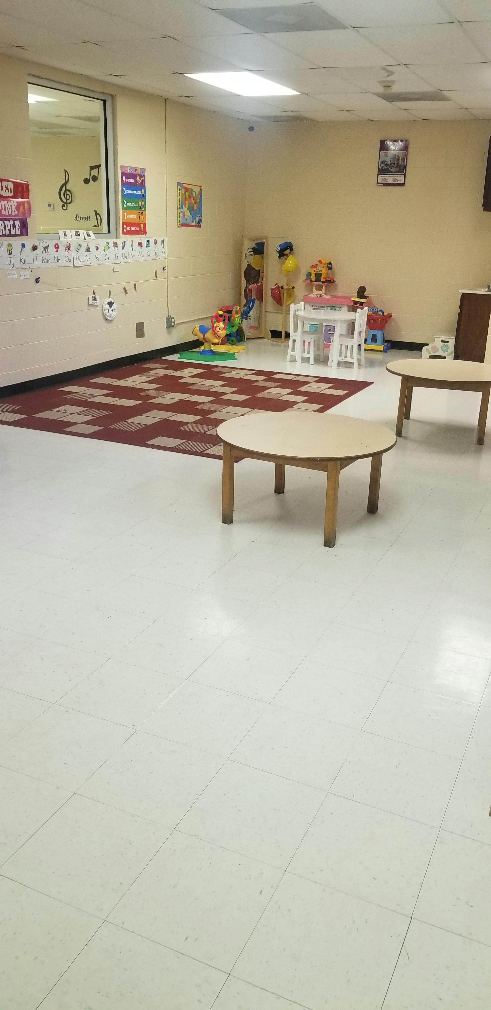 Classroom with small tables, chairs, and toys