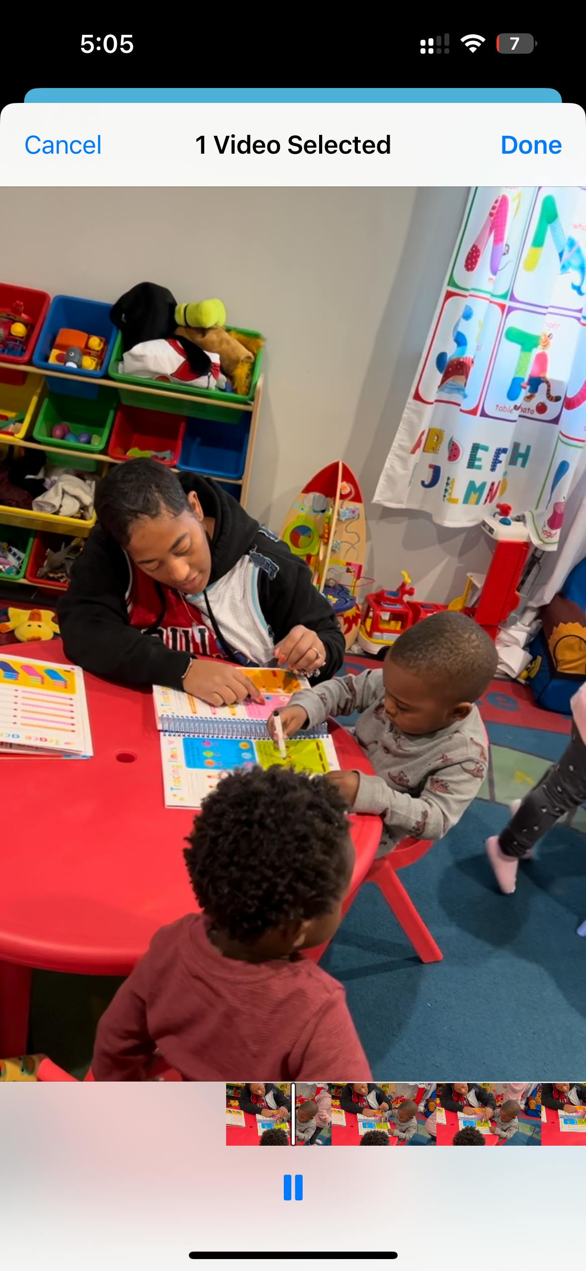 Person and two children at a red table with books