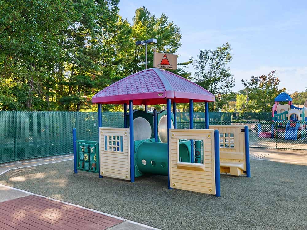 A colorful outdoor playground with climbing structures and slides