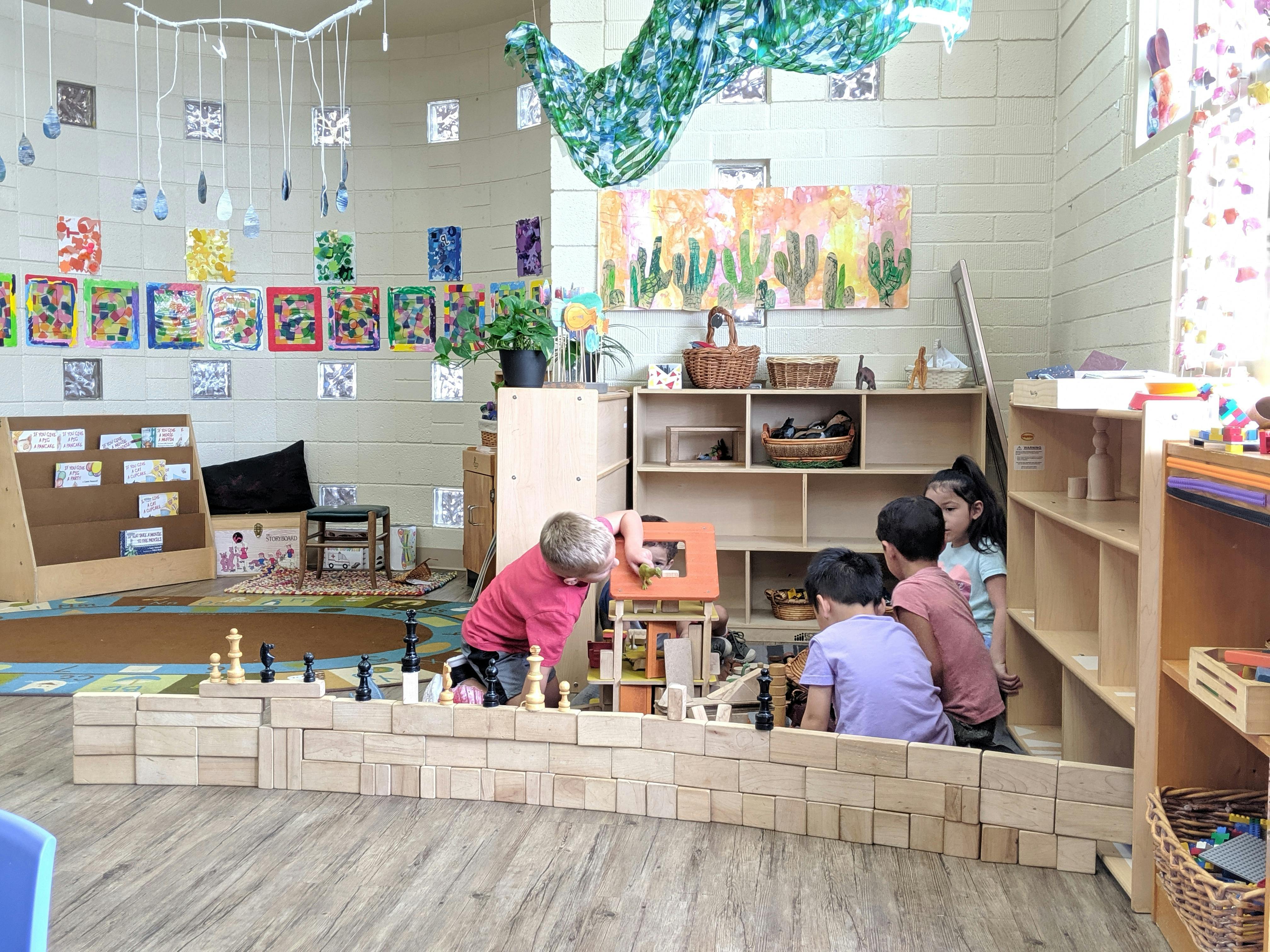 Children playing with wooden blocks in a classroom