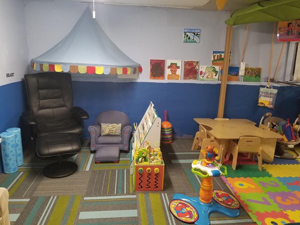 Children's play area with small tables, chairs, and toys