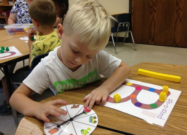 Child playing a board game with a spinner