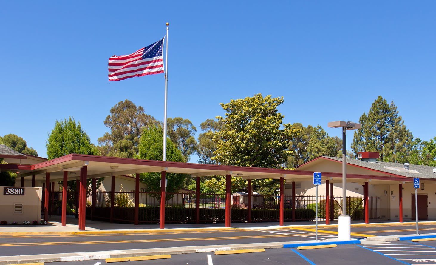 American flag flying above a covered walkway at a building
