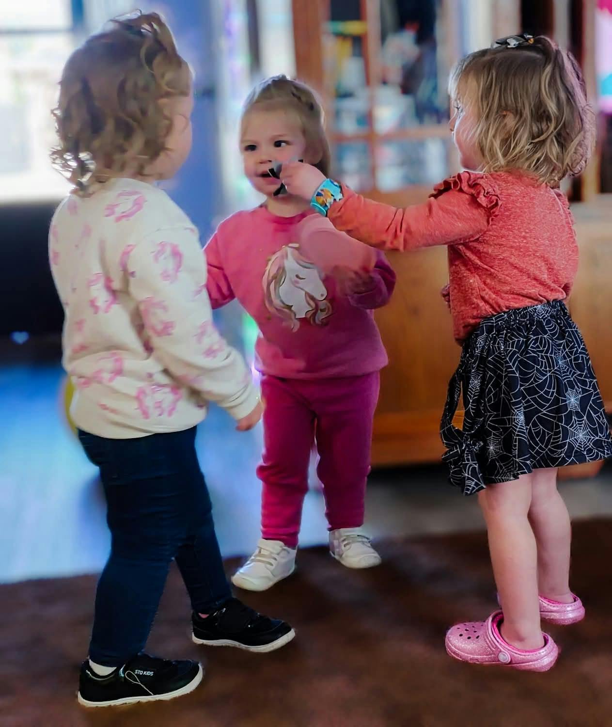 Three children playing together indoors