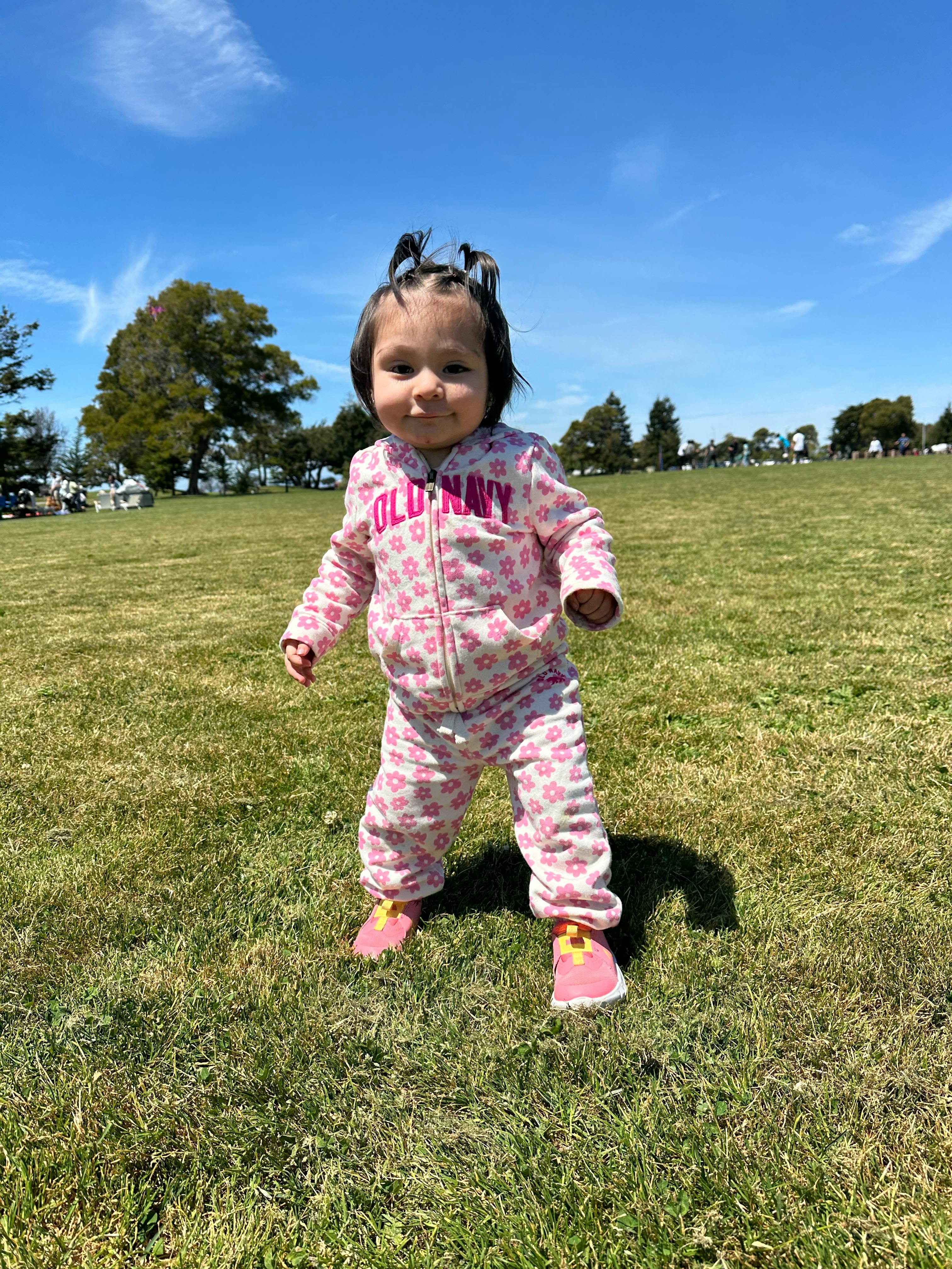Child standing in a grassy field