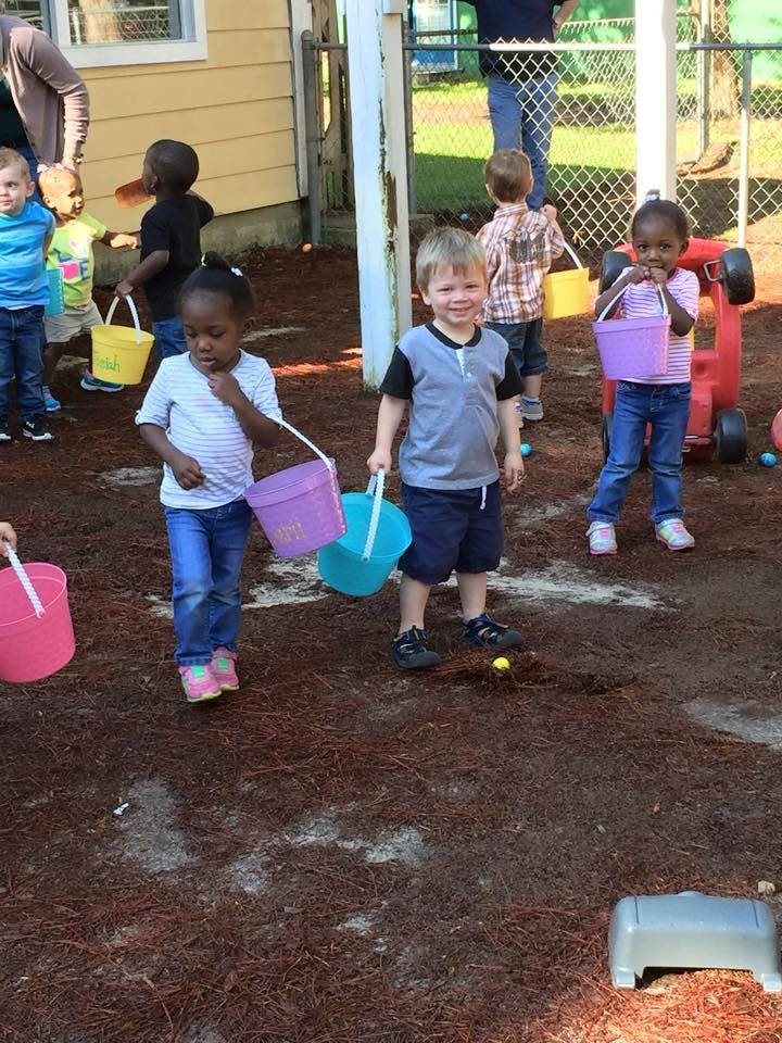 Children holding buckets outdoors