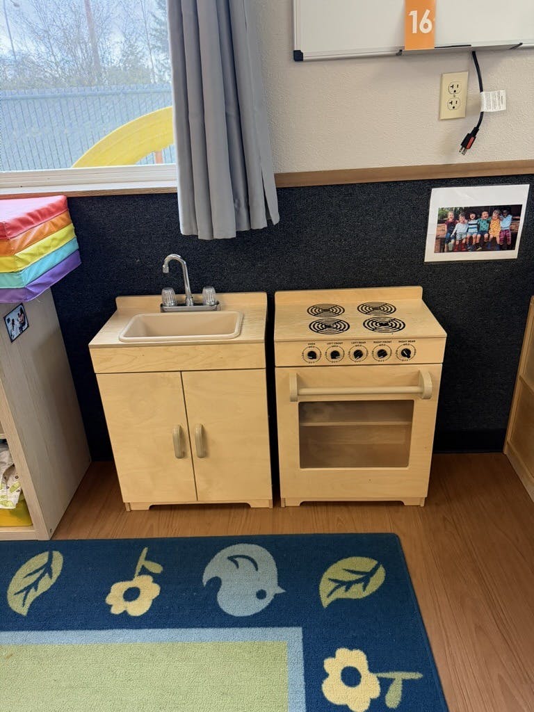 Toy kitchen set with a sink and an oven