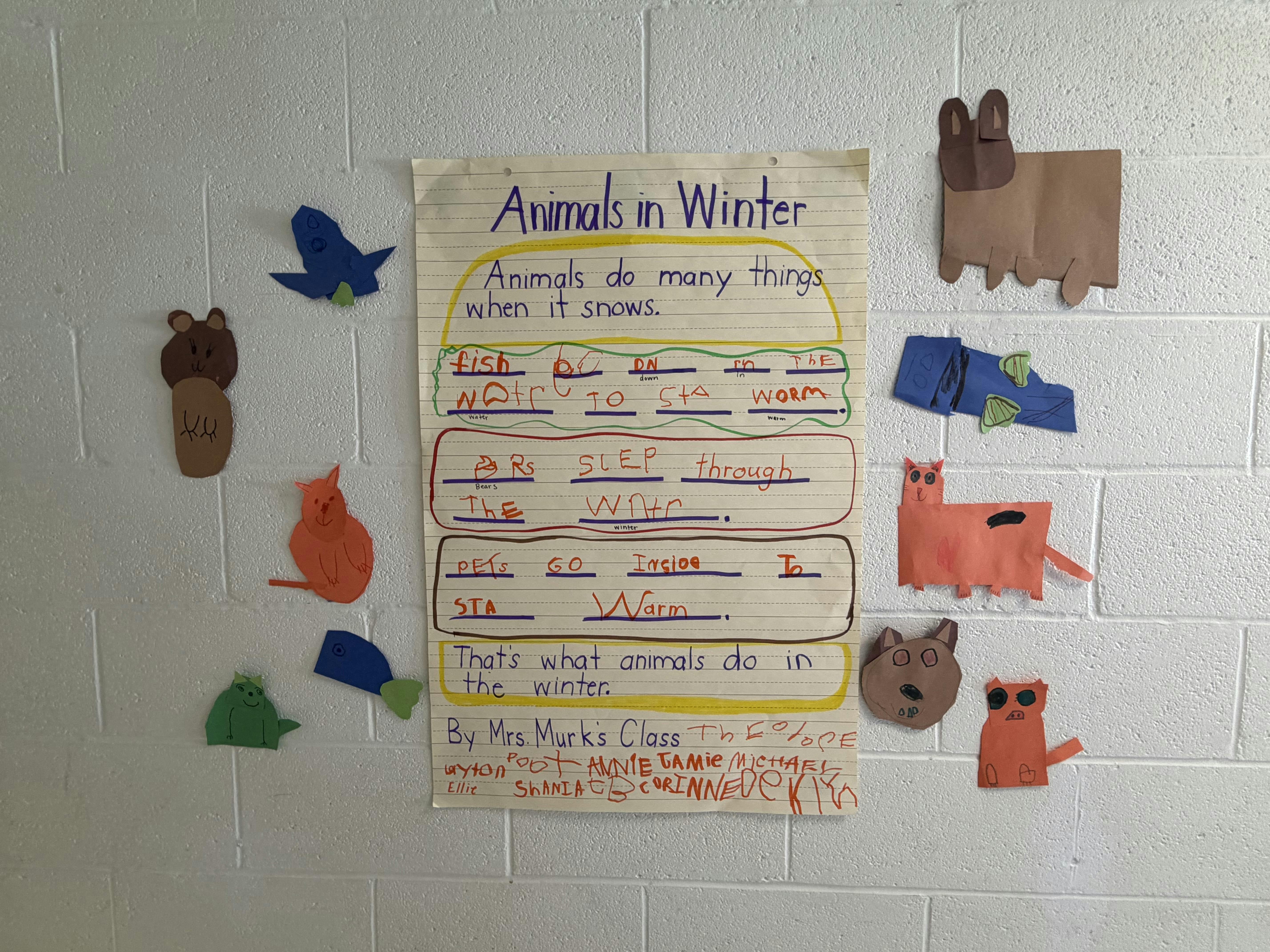 Classroom bulletin board with "Animals in Winter" chart and animal paper cutouts