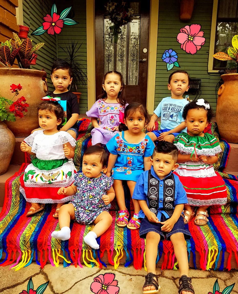 Group of children sitting on a colorful blanket