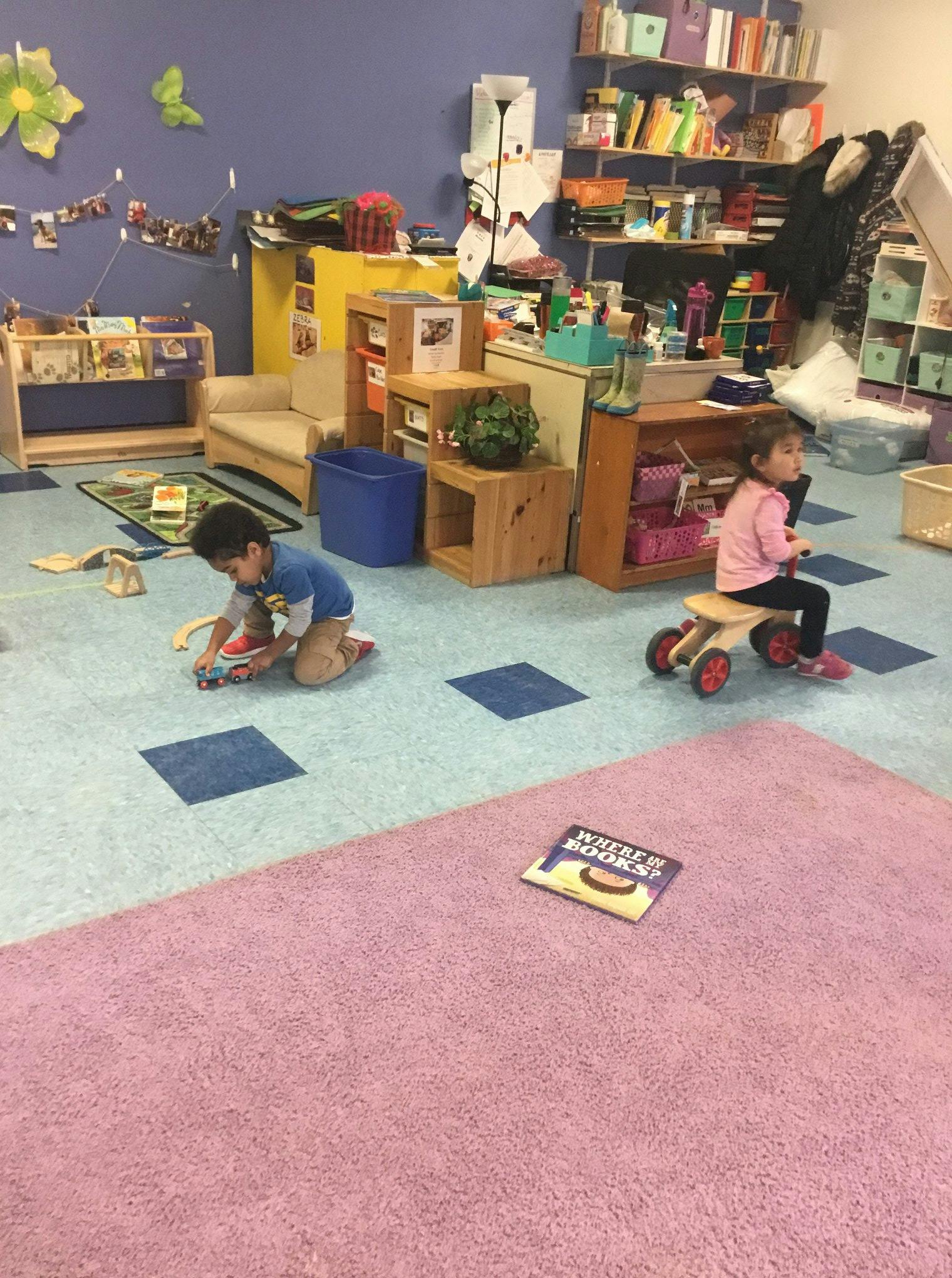 Two children playing in a classroom