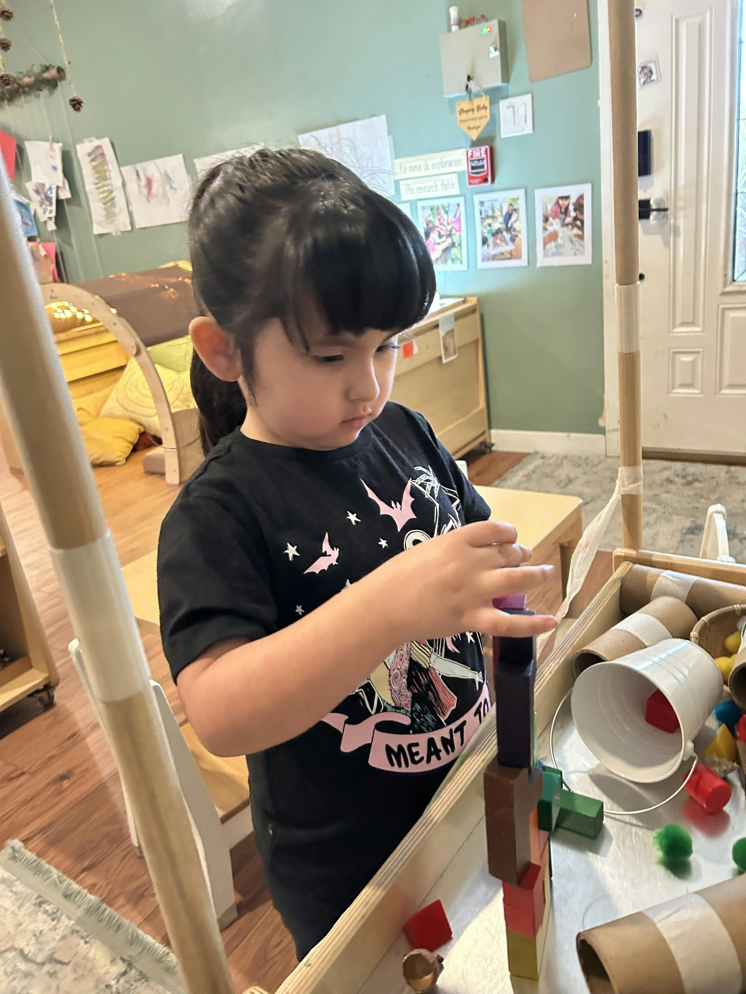 Child building with colorful blocks in a classroom