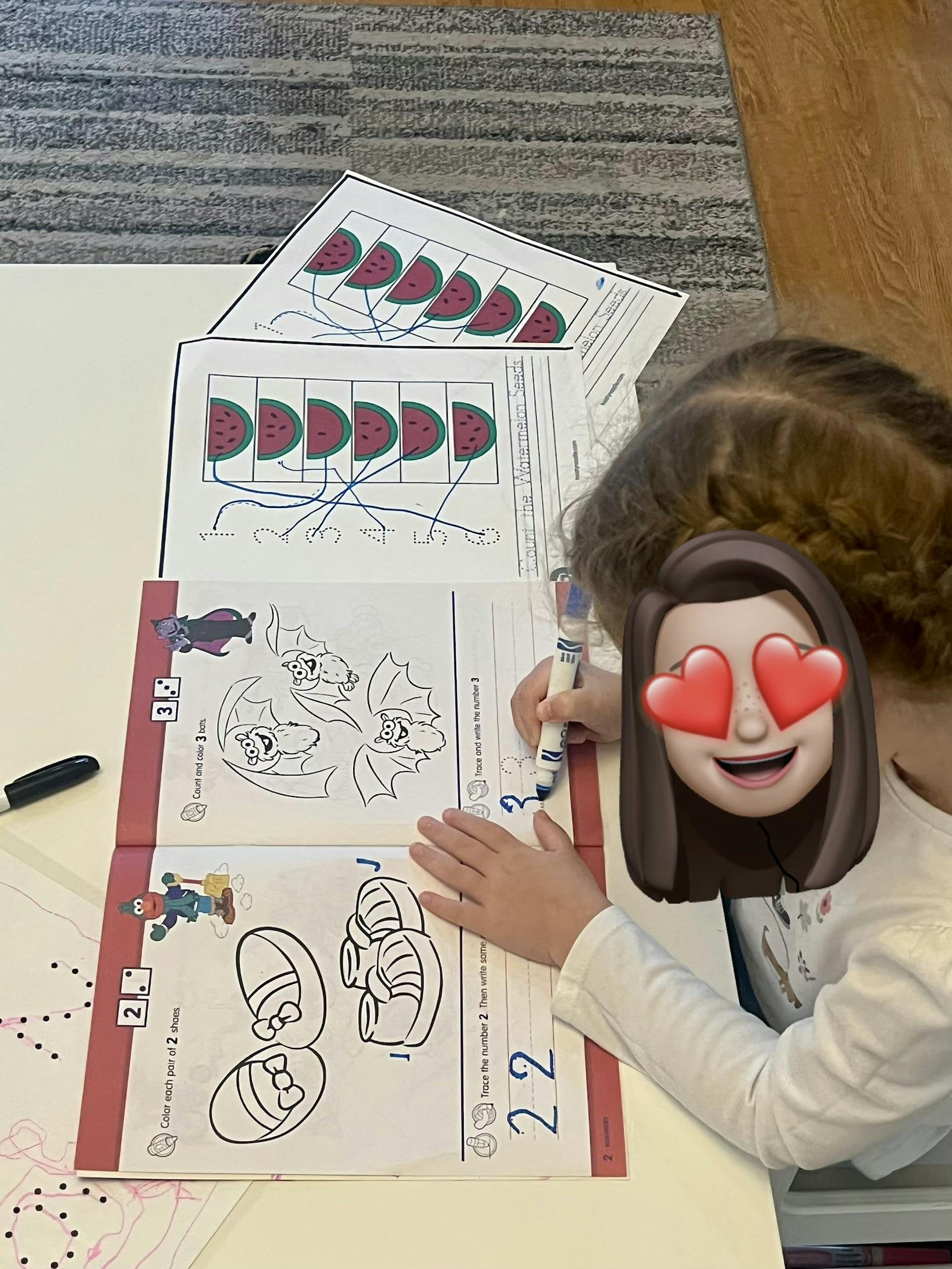 Child completing a math worksheet with number tracing and coloring activities