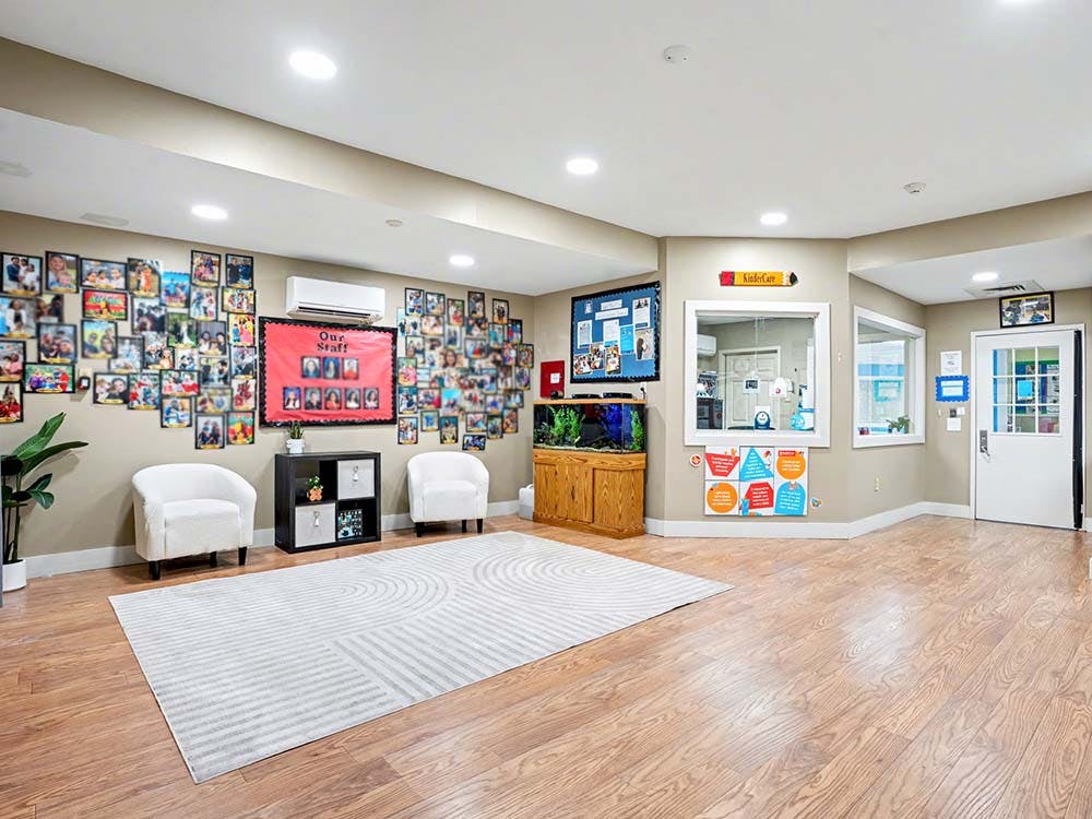 Lobby area with walls covered in framed photos and a staff board
