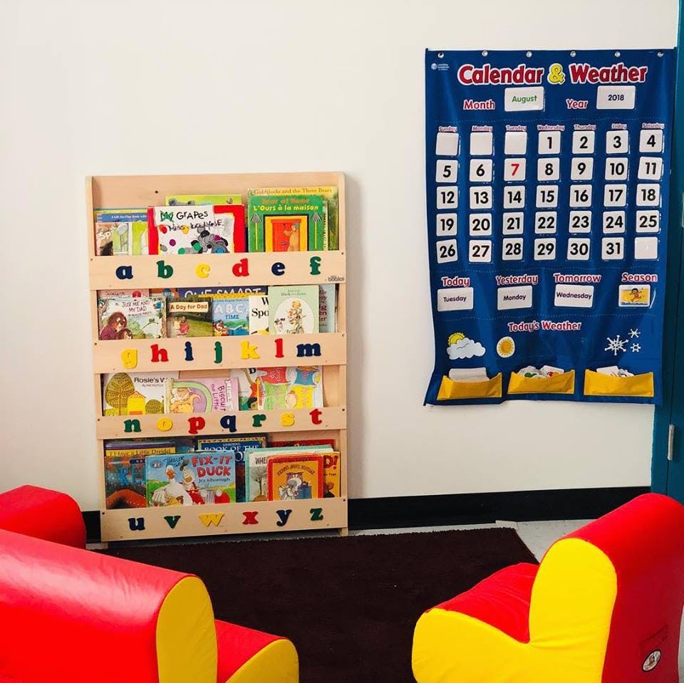Bookshelf with alphabet letters and a calendar on the wall
