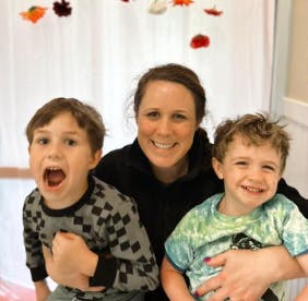 Adult and two children posing for a photo
