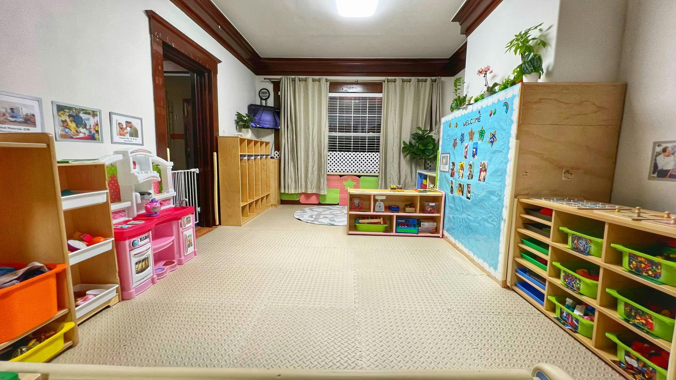 Playroom with shelves, toys, and a bulletin board
