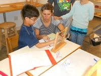 Adult and child at a table with an abacus