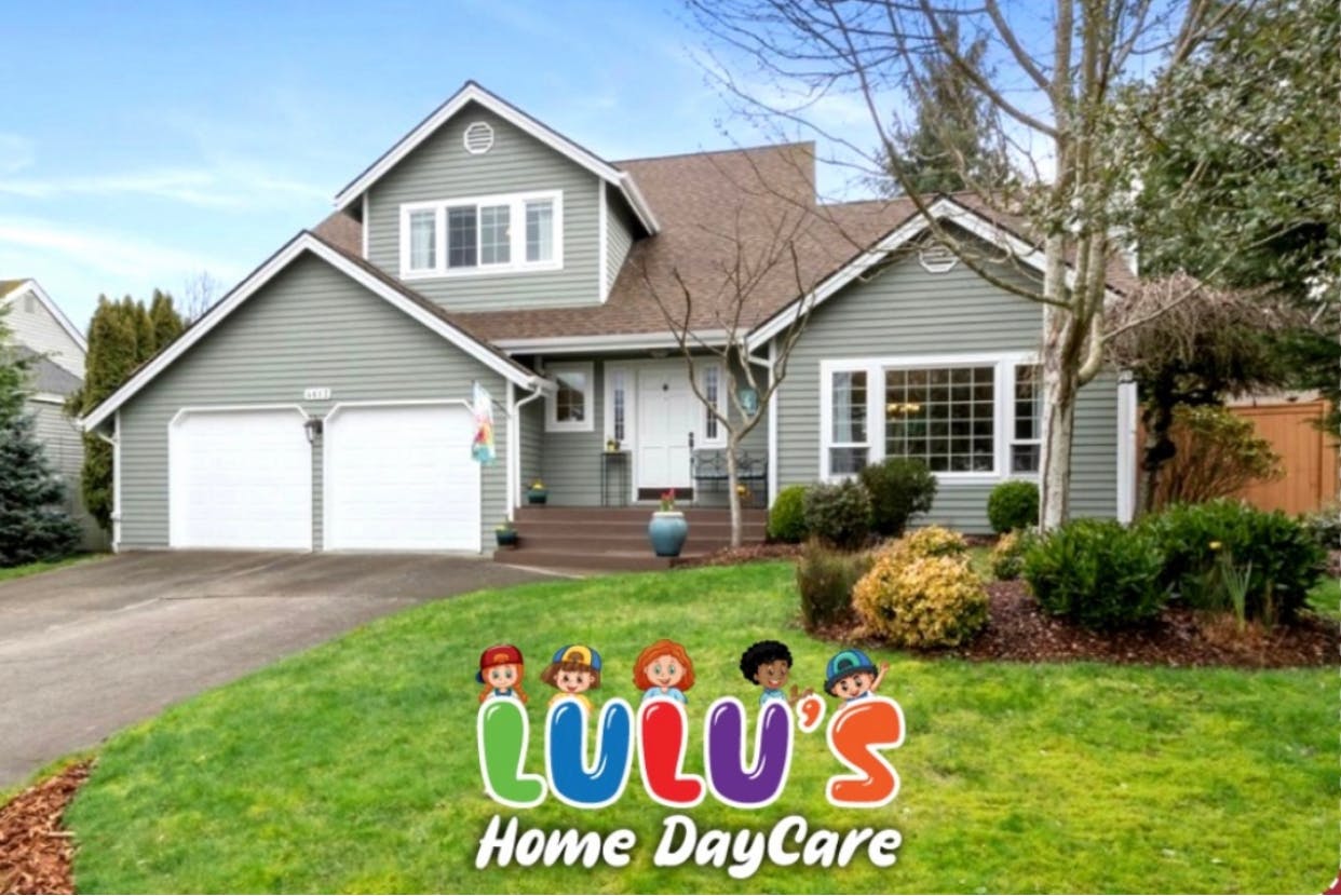 House with a two-car garage and a sign for Lulu's Home DayCare
