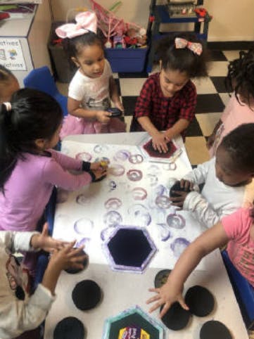 Children making prints with stamps and paint