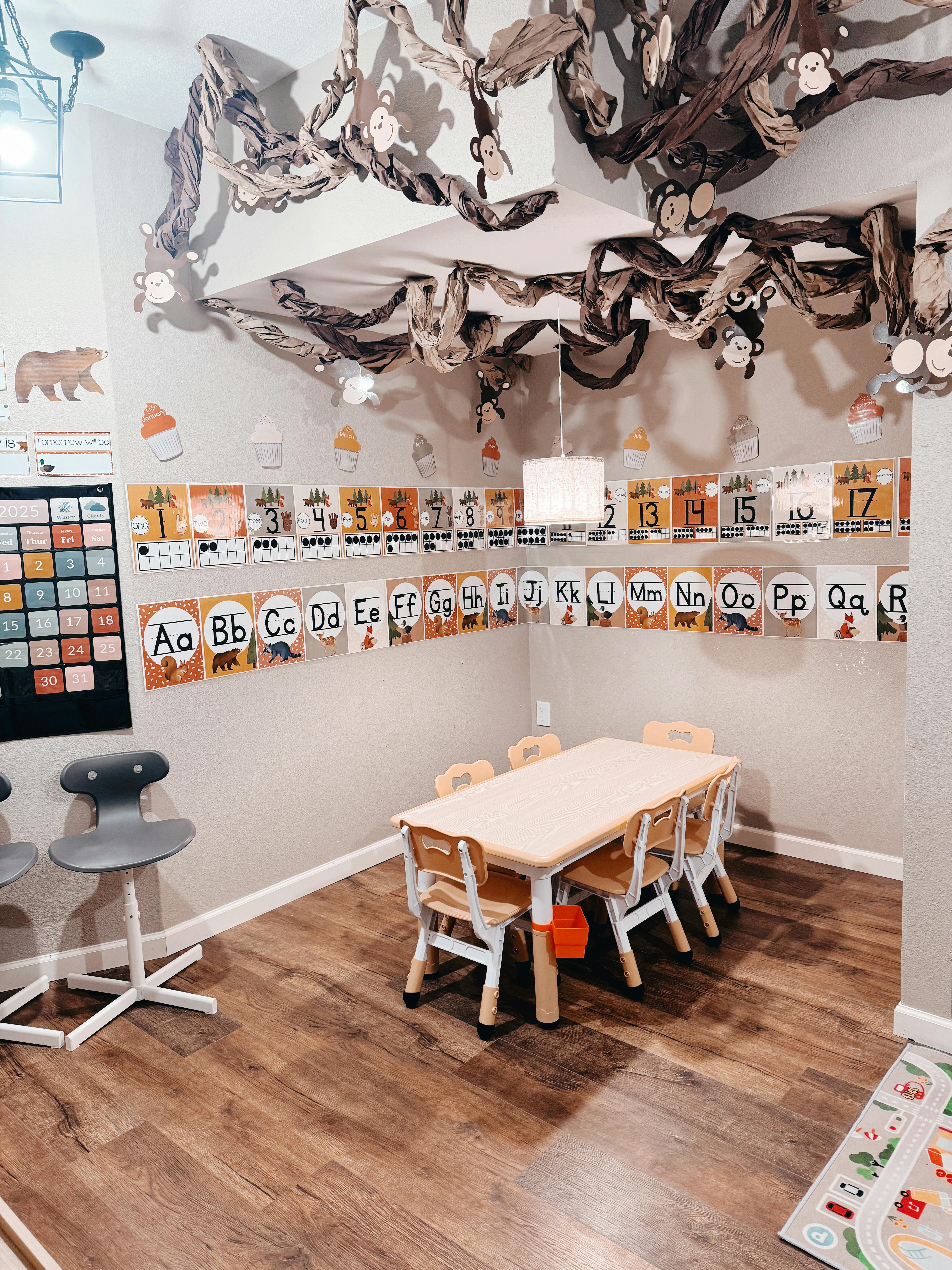Classroom with small table and chairs, alphabet and number charts on wall